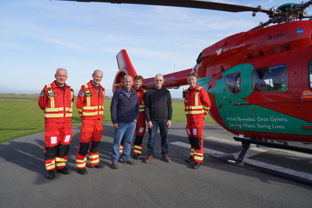 Meryn and Iolo executors with Wales Air Ambulance crew with helicopter in the background